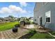 View of outdoor living space, including a built-in grill, outdoor seating, a fire pit and manicured landscaping at 8547 Winton Pl, Pendleton, IN 46064