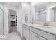 Bright bathroom with double vanity, quartz countertops, and tile flooring, accented by access to a spacious walk-in closet at 8547 Winton Pl, Pendleton, IN 46064