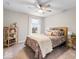 Bedroom with a ceiling fan, a window, a bookshelf, a nightstand, and a floral comforter on the bed at 8547 Winton Pl, Pendleton, IN 46064