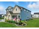 A charming two-story home with lush landscaping and a covered front porch create an inviting curb appeal at 8547 Winton Pl, Pendleton, IN 46064