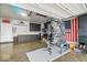 Finished garage with epoxy floors, storage cabinets, gym equipment and 'Welcome to Indianapolis' wall decor at 8547 Winton Pl, Pendleton, IN 46064