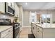 Bright kitchen featuring modern stainless-steel appliances and granite countertops at 8547 Winton Pl, Pendleton, IN 46064