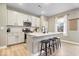 Bright kitchen features white cabinets, granite countertops, and a center island with seating at 8547 Winton Pl, Pendleton, IN 46064
