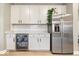 Wet bar area with granite counters, beverage fridge and stainless-steel refrigerator at 8547 Winton Pl, Pendleton, IN 46064