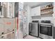 Well-equipped laundry room with modern washer and dryer, shelving, and storage cabinets for convenience at 8547 Winton Pl, Pendleton, IN 46064