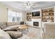 Inviting living room with a cozy fireplace, built-in shelving, and comfortable seating for relaxation at 8547 Winton Pl, Pendleton, IN 46064
