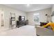 Spacious living room featuring neutral carpeting and walls with a large television and comfortable seating at 8547 Winton Pl, Pendleton, IN 46064