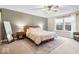 Spacious main bedroom with a large window, ceiling fan, soft rug, and wood furniture at 8547 Winton Pl, Pendleton, IN 46064