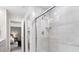The luxurious tiled shower features a glass enclosure, modern fixtures, and recessed lighting, complementing the bathroom design at 8547 Winton Pl, Pendleton, IN 46064