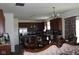 Open kitchen and dining area with stainless steel appliances and dark wood cabinetry at 9068 Thames Dr, Avon, IN 46123