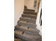 Carpeted staircase featuring decorative stair treads and a white banister railing for a safe and stylish transition between floors at 9068 Thames Dr, Avon, IN 46123