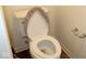 Standard toilet with a textured seat cover provides basic functionality and comfort in this bathroom setting at 9068 Thames Dr, Avon, IN 46123