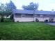 Exterior view of the rear of the home and a large backyard with lawn at 9470 N Old Port Royal, Martinsville, IN 46151