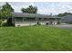 Expansive backyard with lush green lawn, complemented by a brick and siding exterior with mature plants at 9470 N Old Port Royal, Martinsville, IN 46151