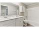 Bathroom featuring double sinks, a large mirror, storage, and a shower with tub at 9498 Tobin Cir, Avon, IN 46123