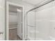Bathroom with glass shower and a doorway into a walk-in closet with wire shelving at 9498 Tobin Cir, Avon, IN 46123