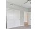 This bedroom features neutral walls, carpeted floors, and closet with sliding panel doors, and a ceiling fan at 9498 Tobin Cir, Avon, IN 46123