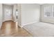 A bedroom with carpet flooring, windows, and a view into a hallway leading to the front door at 9498 Tobin Cir, Avon, IN 46123
