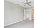 Spacious bedroom featuring neutral walls, carpet flooring, a ceiling fan, and walk-in closet at 9498 Tobin Cir, Avon, IN 46123