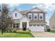 Charming two-story home featuring a well-manicured lawn, white trim, and a two-car garage at 9498 Tobin Cir, Avon, IN 46123