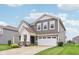 Charming two-story home with a well-manicured lawn, a two-car garage and covered front porch at 9498 Tobin Cir, Avon, IN 46123