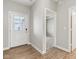 Hallway with exterior door, wood floors, and doorways leading to various rooms in the house at 9498 Tobin Cir, Avon, IN 46123