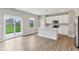 Modern kitchen featuring an island, white cabinets, and a sliding door to the outside at 9498 Tobin Cir, Avon, IN 46123