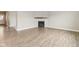 Bright living room showcasing a fireplace, wood flooring, and ample space for entertaining at 9498 Tobin Cir, Avon, IN 46123