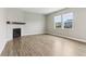The airy living room showcases a fireplace, hardwood floors, and natural light at 9498 Tobin Cir, Avon, IN 46123