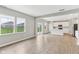 A bright living area transitions into a modern kitchen with large windows at 9498 Tobin Cir, Avon, IN 46123