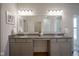 Double sink bathroom with modern fixtures, large mirror, and granite countertops at 9728 Junction, Fishers, IN 46037