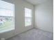 Bright bedroom with neutral carpet and two large windows offering neighborhood views at 9728 Junction, Fishers, IN 46037