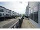 View along a row of townhomes from a private wooden deck with a black metal railing at 9728 Junction, Fishers, IN 46037