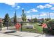 Enclosed dog park area with green space, play equipment, and signage under a bright blue sky with scattered clouds at 9728 Junction, Fishers, IN 46037