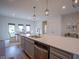 Modern kitchen with stainless steel appliances, quartz countertops, and dining area at 9728 Junction, Fishers, IN 46037