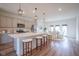 Modern kitchen with a large island, stainless steel appliances, and stylish pendant lighting at 9728 Junction, Fishers, IN 46037