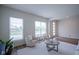 Bright living room features contemporary seating, hardwood floors, and an abundance of natural light at 9728 Junction, Fishers, IN 46037