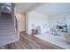 Open-concept living room with modern staircase, hardwood floors, and contemporary furnishings at 9728 Junction, Fishers, IN 46037