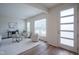 Bright living room with modern furnishings, neutral tones, hardwood flooring, and ample natural light at 9728 Junction, Fishers, IN 46037