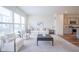 Bright and airy living room with a kitchen view, large windows, and modern decor at 9728 Junction, Fishers, IN 46037
