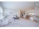 Spacious open-concept living room with carpet, kitchen with island, and dining area at 9728 Junction, Fishers, IN 46037