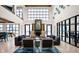 Bright lobby with high ceilings, comfortable seating, and fireplace with decor at 9728 Junction, Fishers, IN 46037