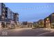 A well-lit street view with string lights, businesses, and parking spaces in a commercial area at dusk at 9728 Junction, Fishers, IN 46037