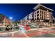 Inviting street view with lights and a restaurant, featuring outdoor seating in a vibrant commercial area at night at 9728 Junction, Fishers, IN 46037