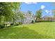 A lush, green lawn stretches out to a two-story house with a deck and beautiful yard at 9985 Ford Valley Ln, Zionsville, IN 46077