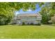 Large, two-story home with a gray exterior surrounded by a spacious, green lawn at 9985 Ford Valley Ln, Zionsville, IN 46077