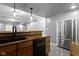 The wet bar offers a sink, wood cabinets, a dishwasher and a stainless-steel refrigerator at 9985 Ford Valley Ln, Zionsville, IN 46077