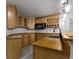 A closer view of the custom wet bar showcasing wood cabinets, a microwave and wine storage at 9985 Ford Valley Ln, Zionsville, IN 46077