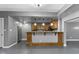 Basement bar area features custom wood cabinets, a microwave, wine rack and pendant lighting at 9985 Ford Valley Ln, Zionsville, IN 46077