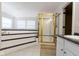 Bathroom featuring a large tub with tile surround and glass-enclosed shower at 9985 Ford Valley Ln, Zionsville, IN 46077